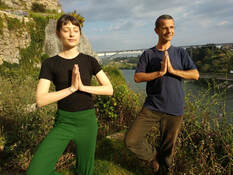pareja en pose de yoga en oporto al Rio Duero